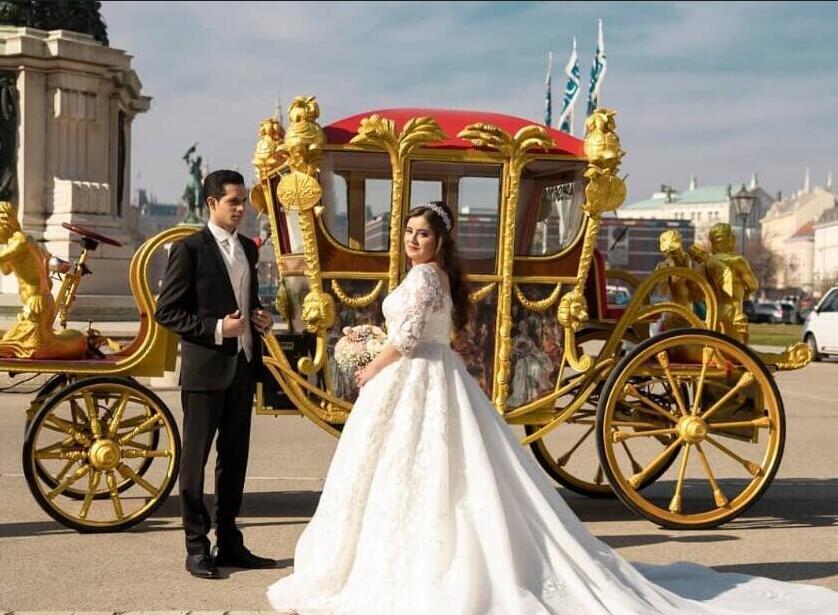 Bride and groom sharing a romantic moment in a beautifully decorated horse-drawn carriage.